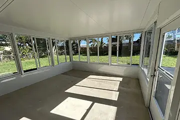 Screen room with white sliding windows
